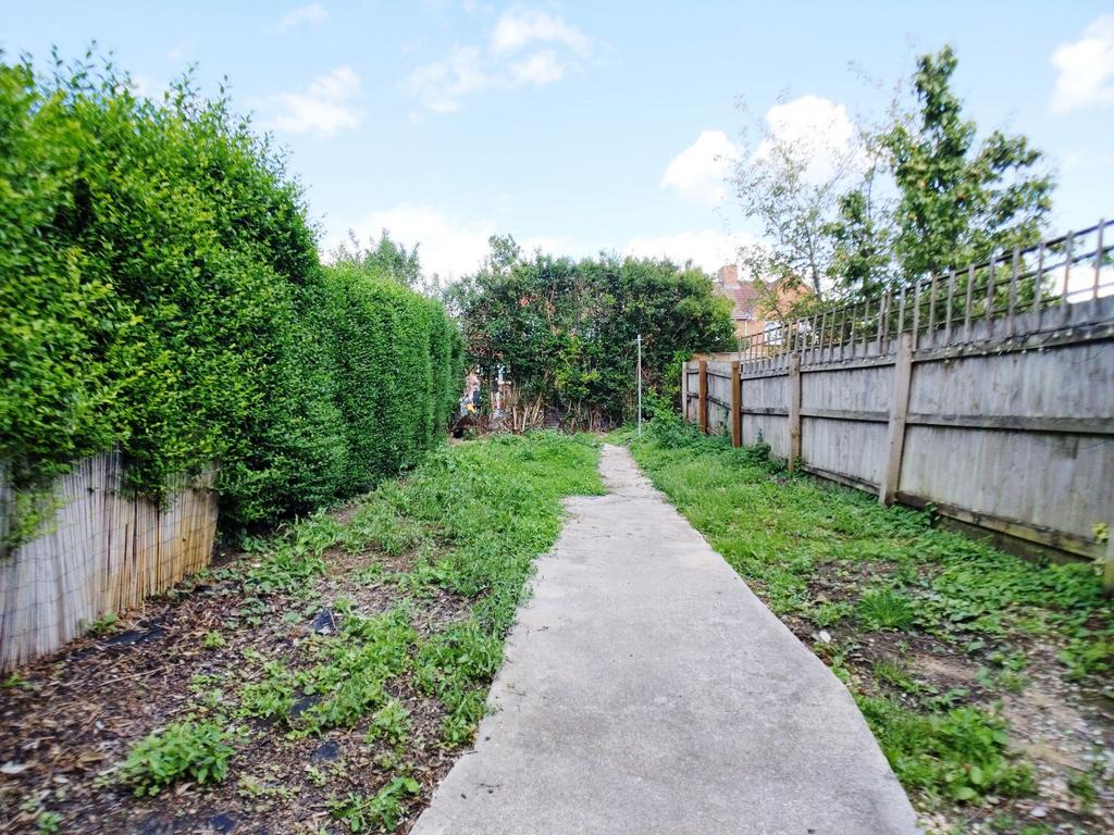 Private rear garden with a paved central path, ...