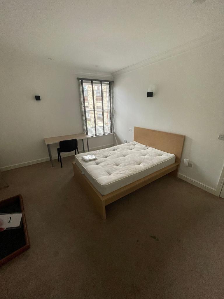 Bright, simply furnished double bedroom with a ...