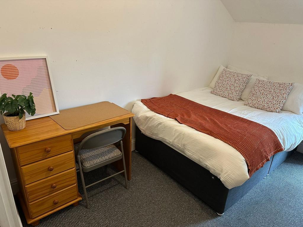 A cozy and well-maintained master bedroom featu...