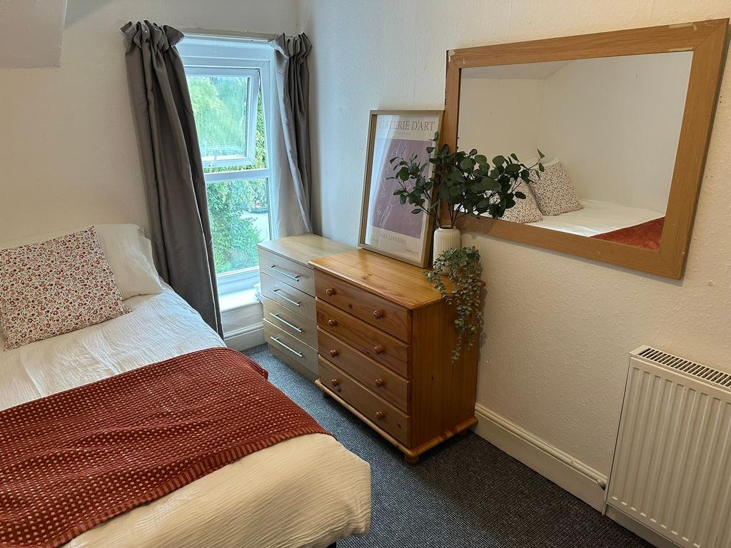 Cozy double bedroom featuring a comfortable bed...