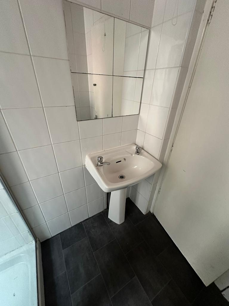 Clean and functional bathroom with a white sink...