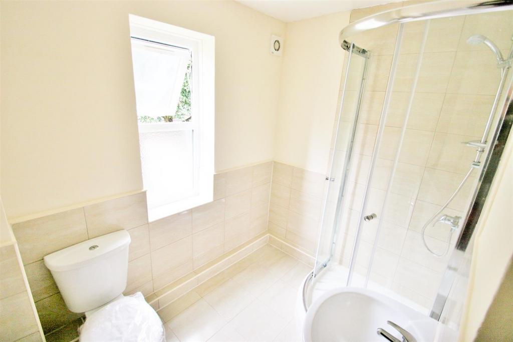 Bright and clean bathroom featuring a modern sh...