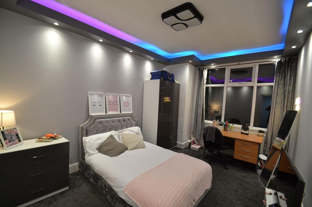 Stylish double bedroom with a plush upholstered...