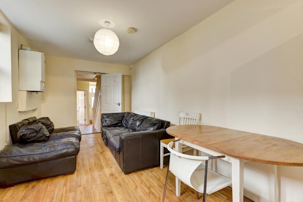 Bright, unfussy living room with wooden floors,...
