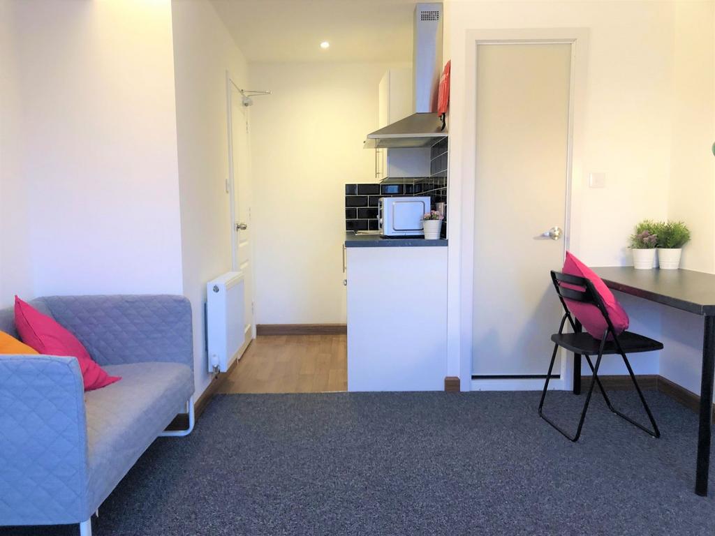 Bright and tidy living room featuring a comfort...