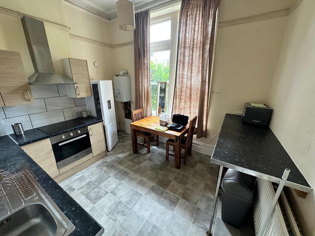 Bright eat-in kitchen with tiled flooring, fitt...