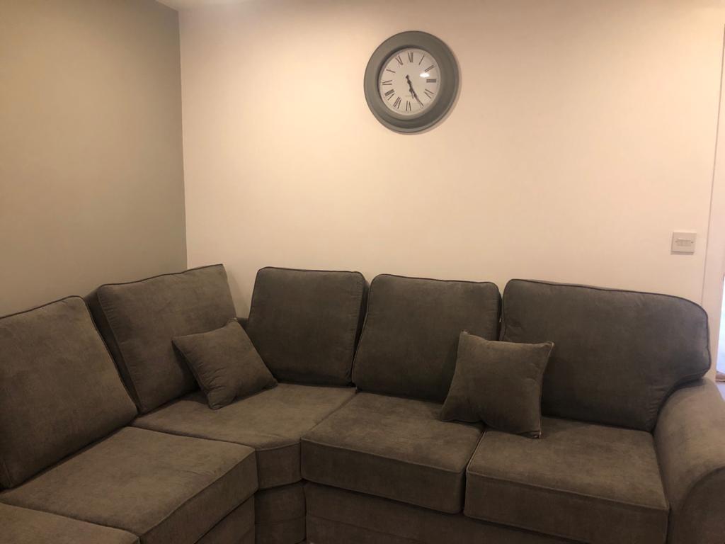 Bright, neutral living room with a comfortable ...