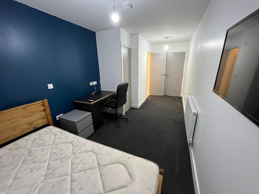 Bright, modern bedroom with a statement blue fe...