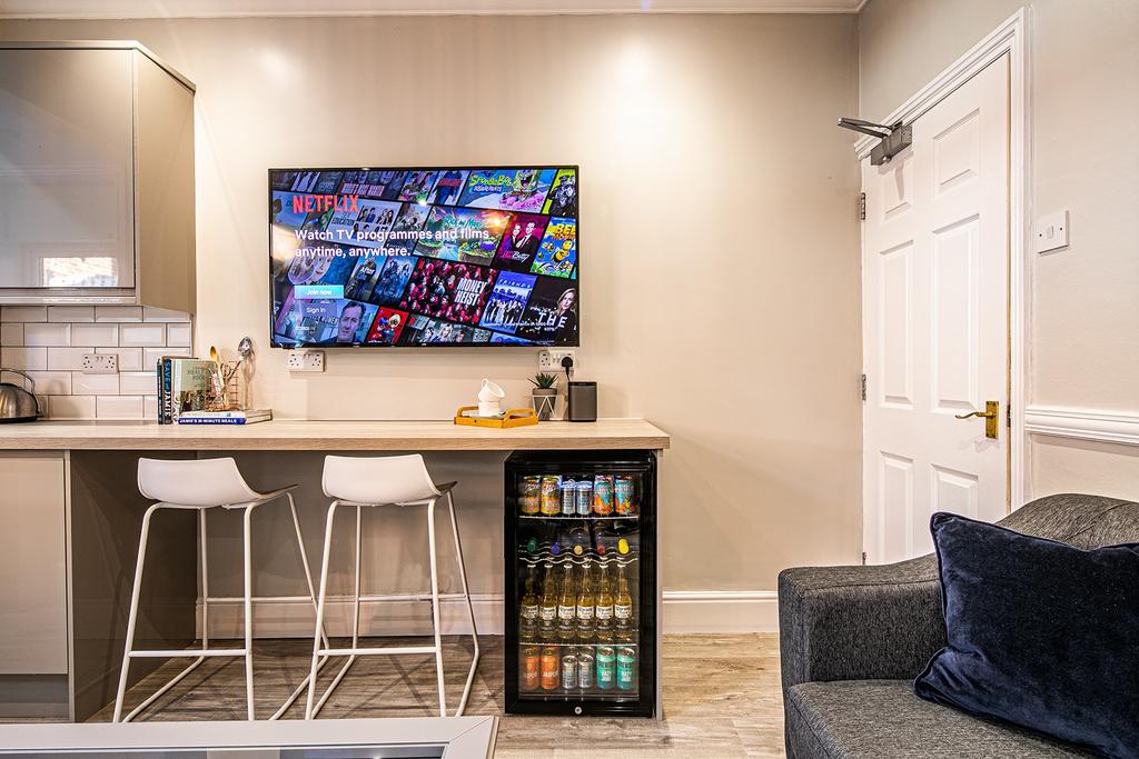 A modern living room with a large flat-screen T...
