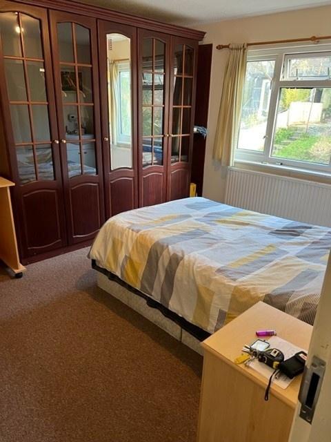 Bright double bedroom with a large fitted wardr...