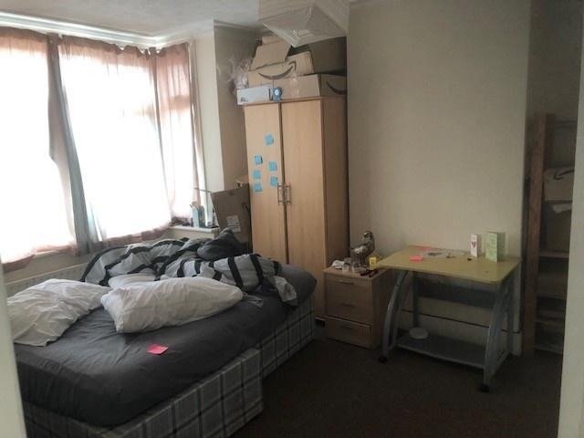 Bright bedroom with a large window, natural lig...