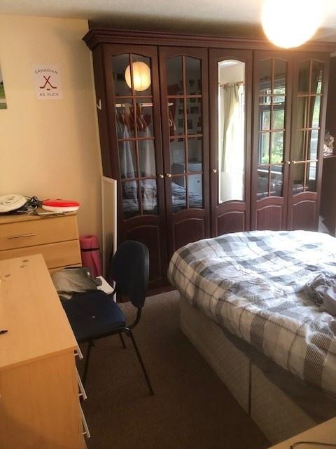 Bright, well-kept master bedroom with a large d...