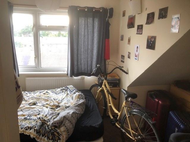 Cosy bedroom with a large window, radiator bene...
