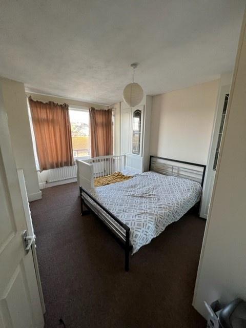 Bright double bedroom with a metal framed doubl...
