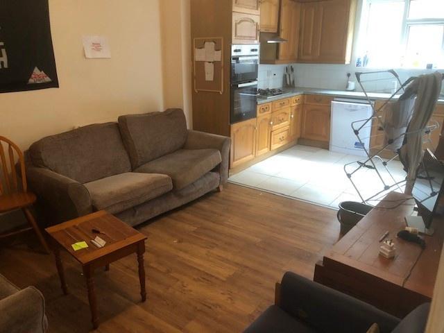 Bright, open-plan living area with a compact ki...