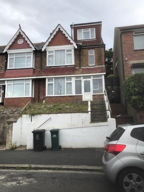 Traditional semi-detached brick house with a ra...