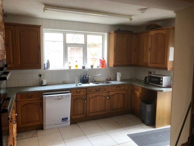Bright, well-equipped kitchen with ample wooden...