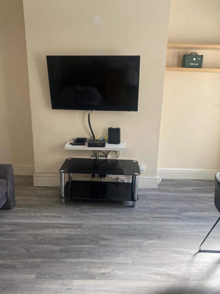 Contemporary living area with a wall-mounted TV...