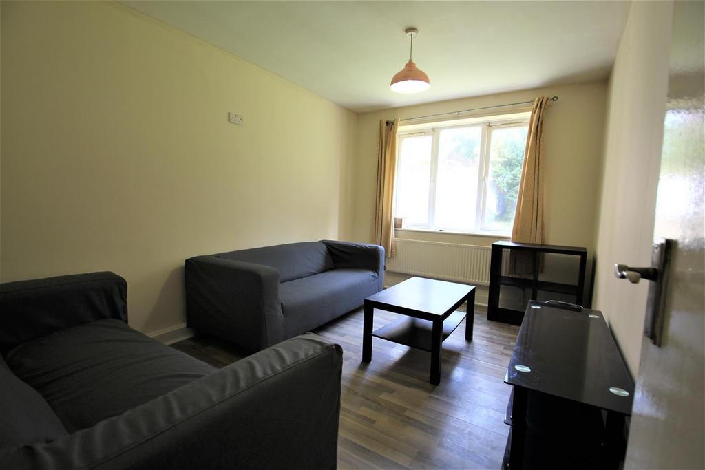 Bright, simply furnished living room with two s...
