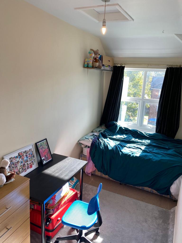A bright and cozy bedroom featuring a double be...