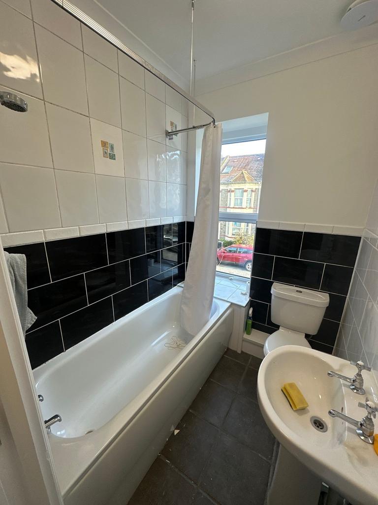Bright, modern bathroom with a full-size bathtu...