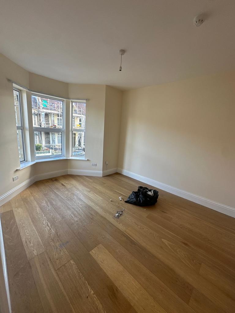 Bright bedroom with a bay window and newly laid...