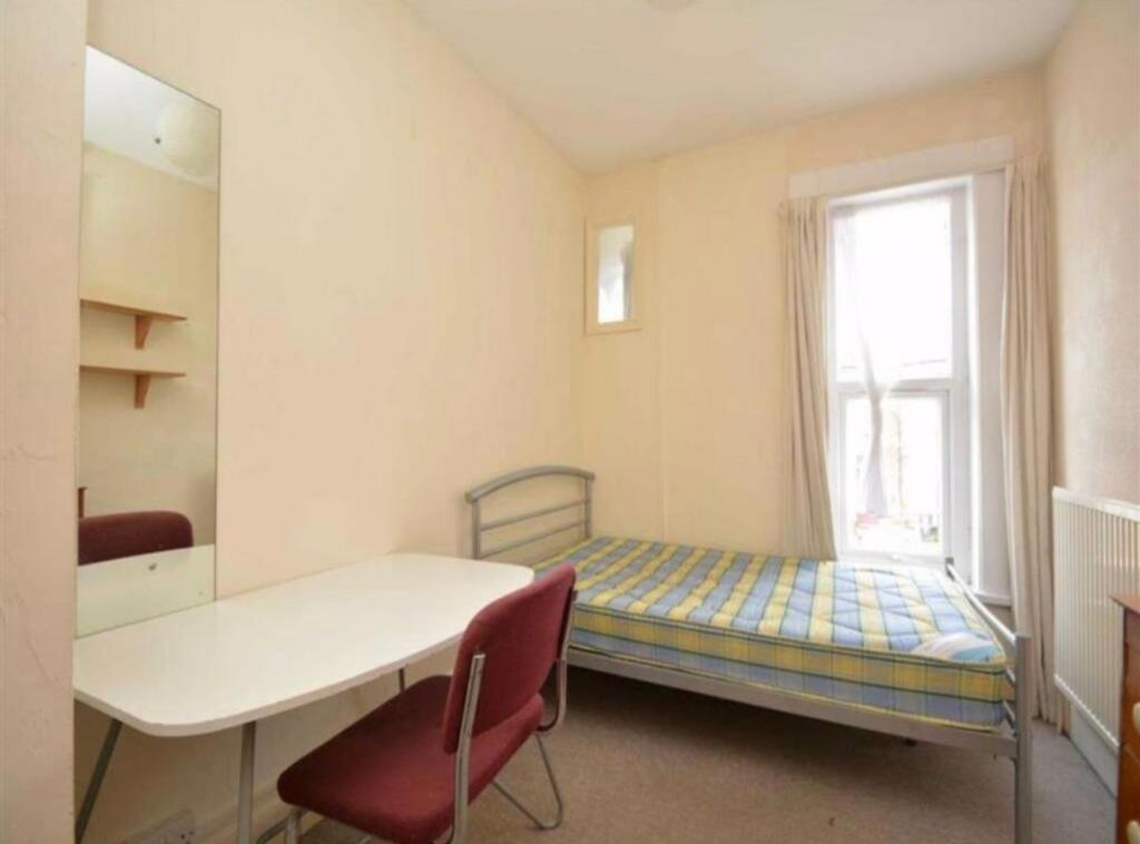 A cozy single bedroom with ample natural light ...