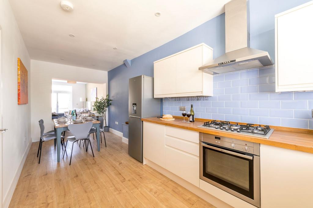 Bright modern kitchen with integrated oven and ...