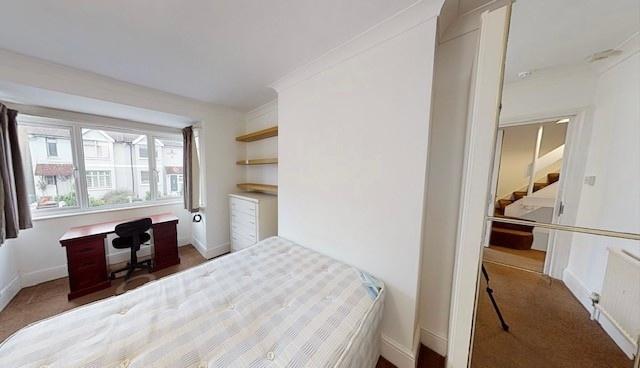 A bright, welcoming bedroom with a double bed a...
