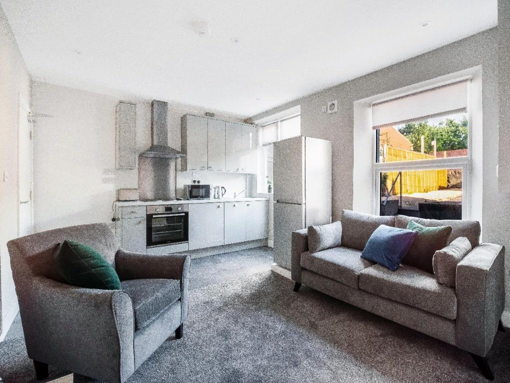 Bright open-plan living area with a fitted kitc...