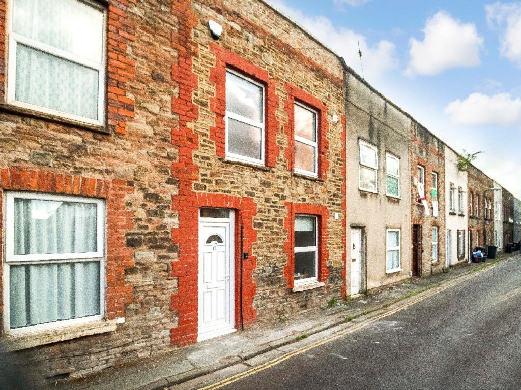 Traditional stone-and-brick terraced street wit...