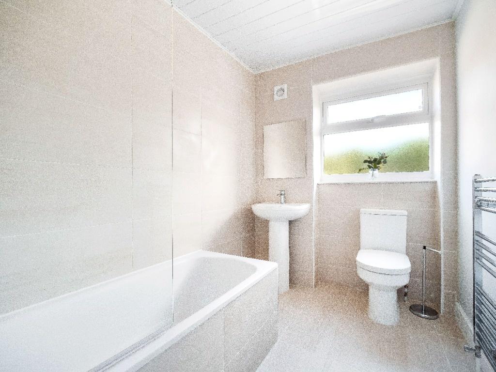 Bright, modern bathroom with a full bath and cr...