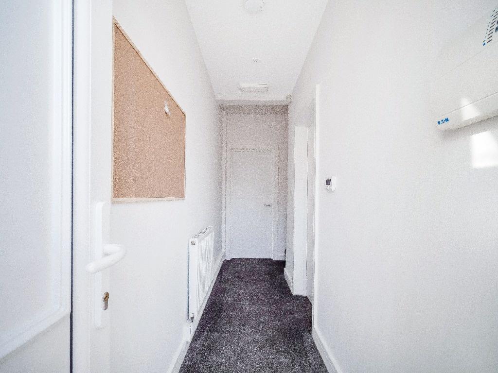 Bright, freshly painted hallway with neutral de...
