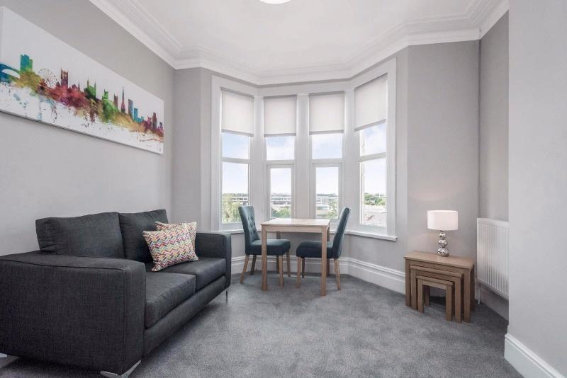 Bright, stylish living room with a bay window, ...