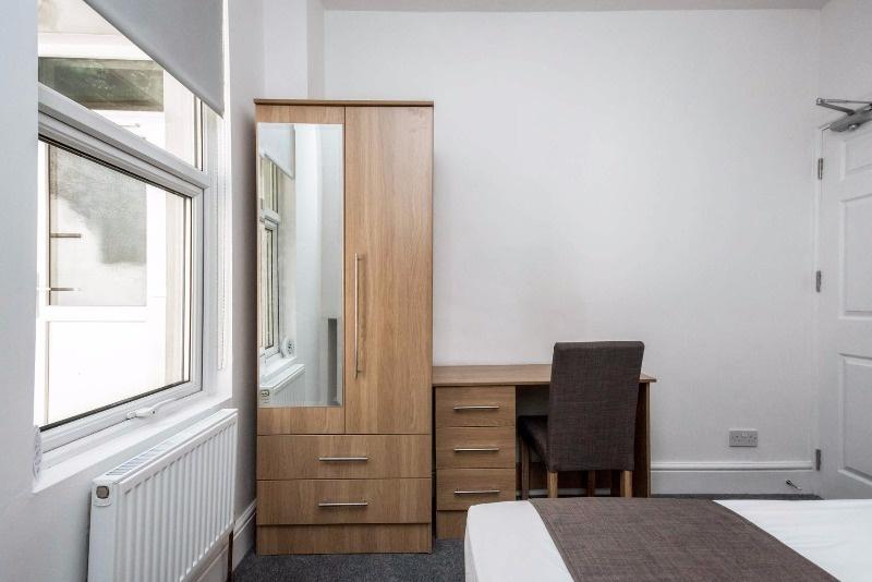 Bright, neatly presented bedroom with a large f...