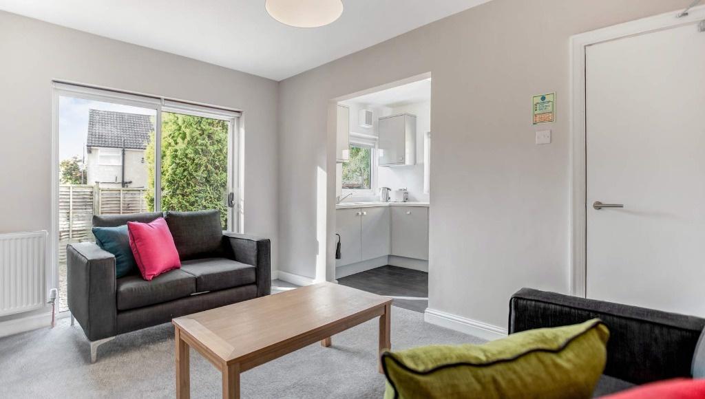 Bright, modern living room with a comfortable t...