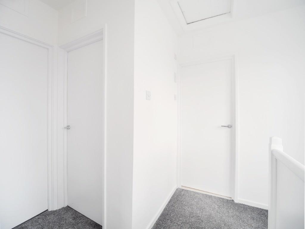 Bright, freshly painted upstairs hallway with c...