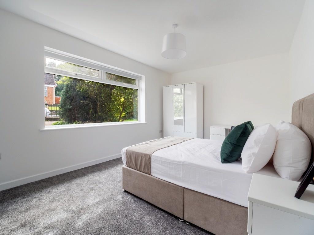Bright, freshly decorated double bedroom with a...