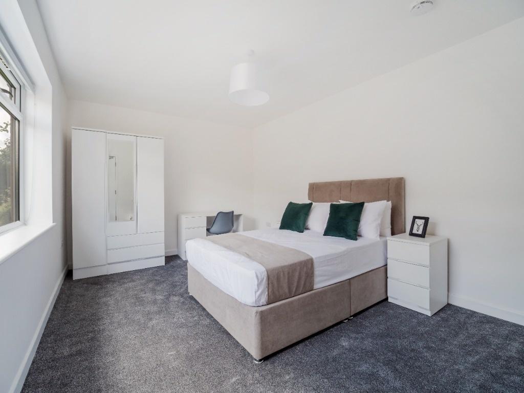 Bright, freshly decorated double bedroom with a...