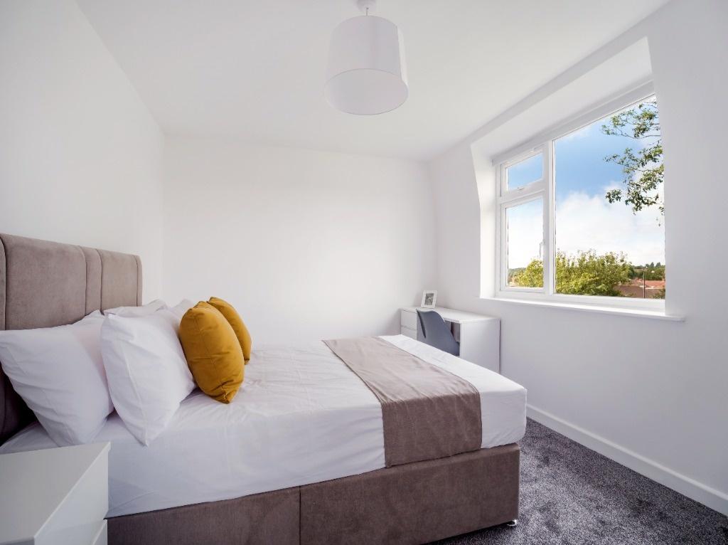Bright, freshly decorated bedroom with a comfor...