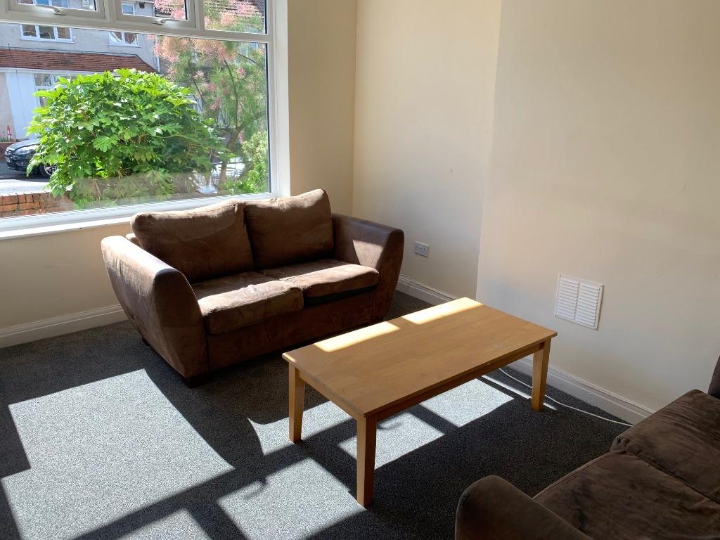 Bright ground-floor living room with large fron...