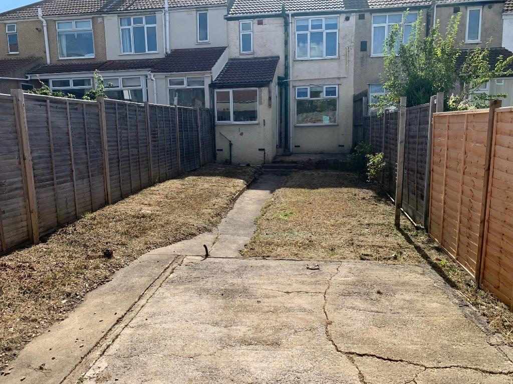 Private rear garden with a central paved path, ...