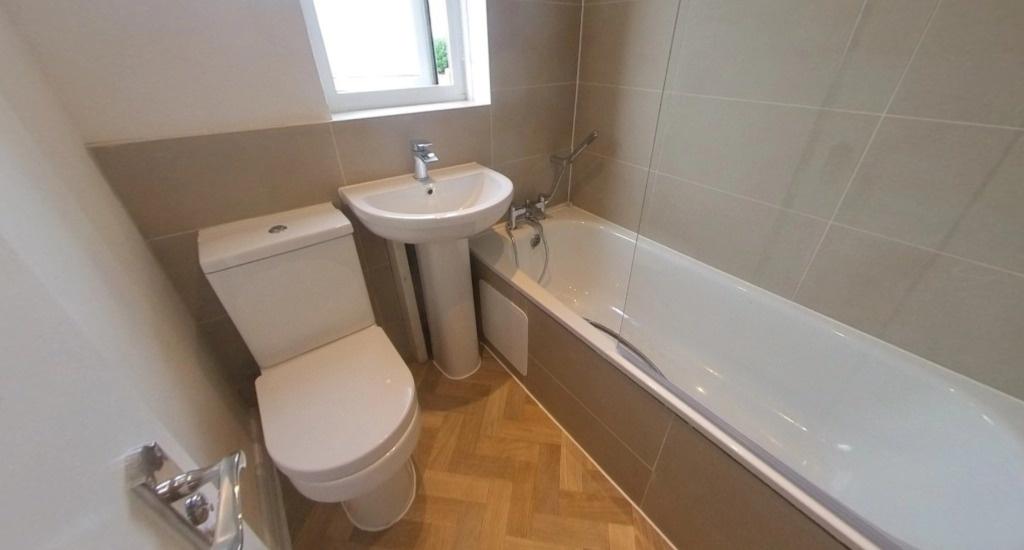 Bright, modern bathroom with a fitted bath, bas...