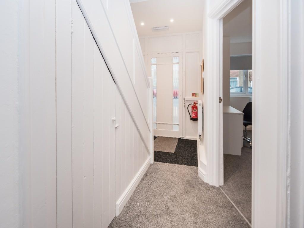 Bright, freshly painted hallway with white pane...