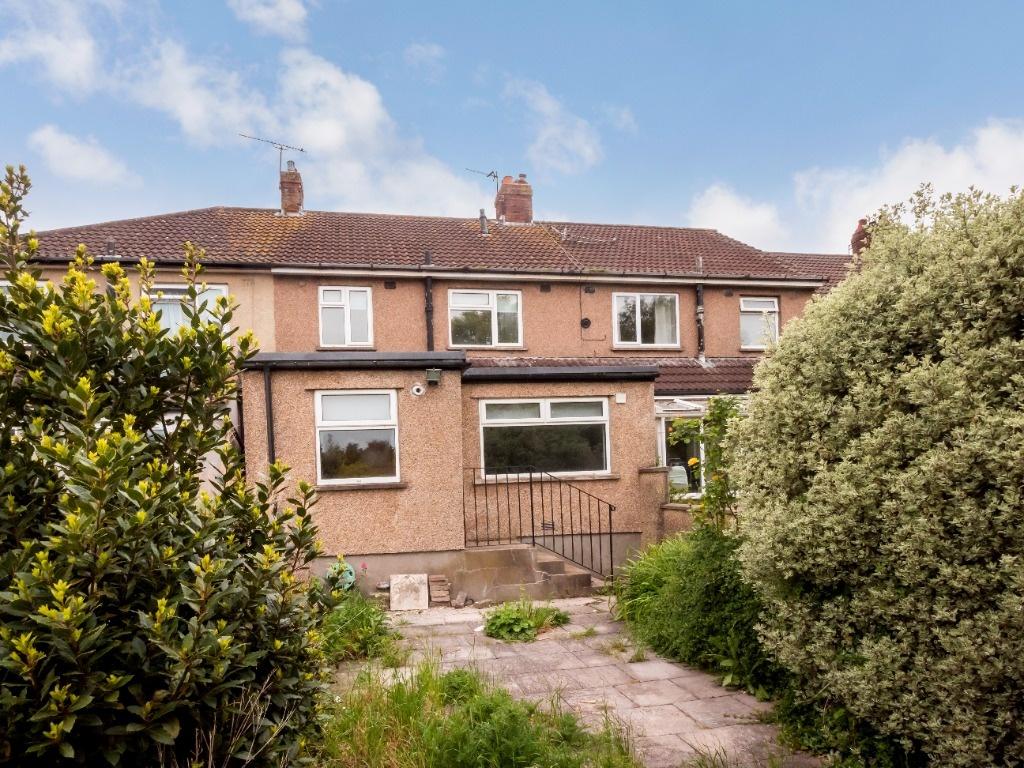 Terraced property with a paved rear garden fram...