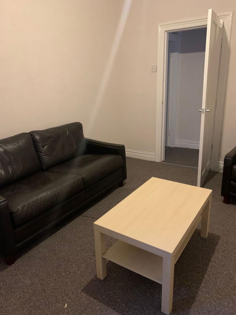 Comfortable shared lounge with leather sofas, a...