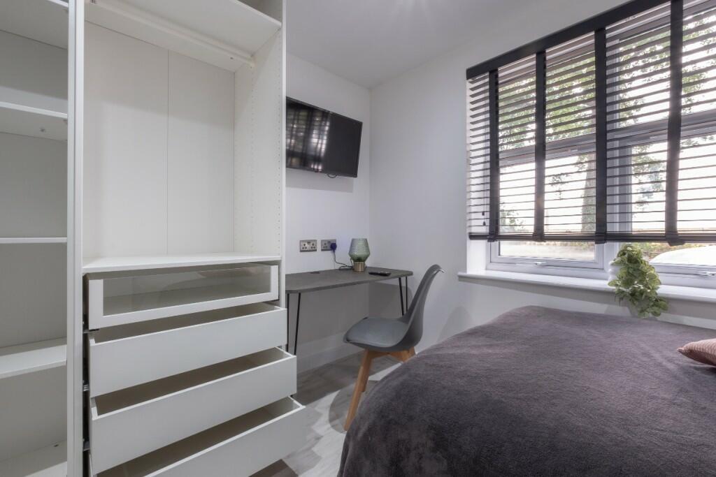A modern and well-maintained bedroom featuring ...