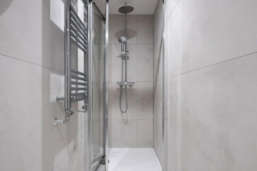 A modern, sleek shower area with contemporary f...