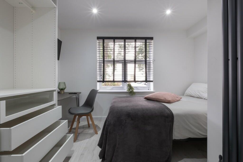 Bright and modern double bedroom featuring a co...