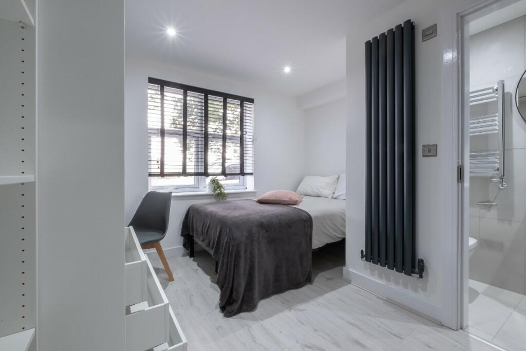 Bright and modern single bedroom featuring a co...
